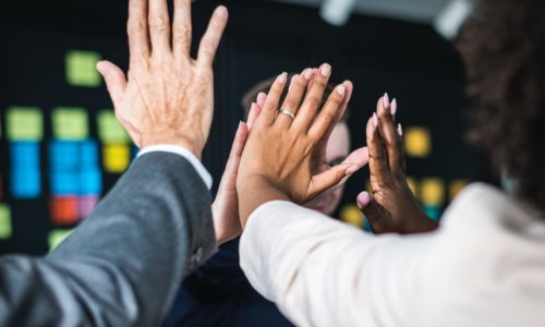 People joining hands in achievement