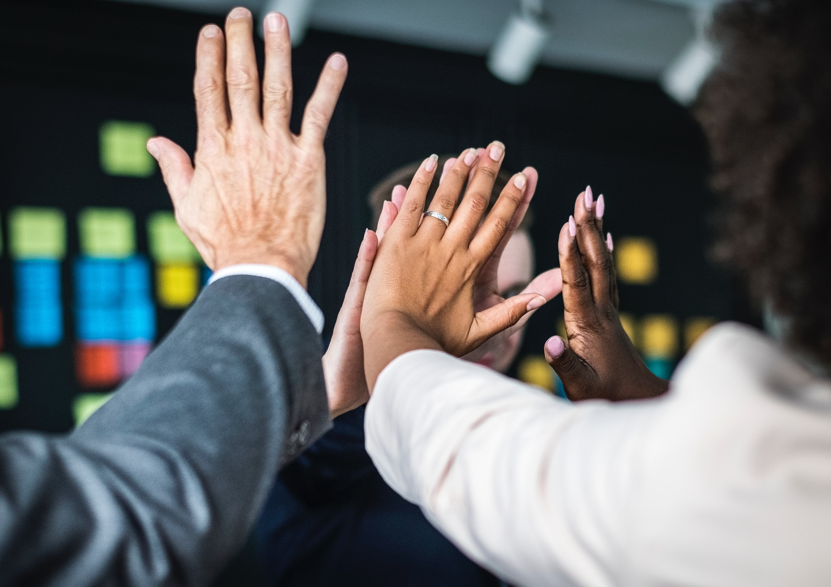 People joining hands in achievement