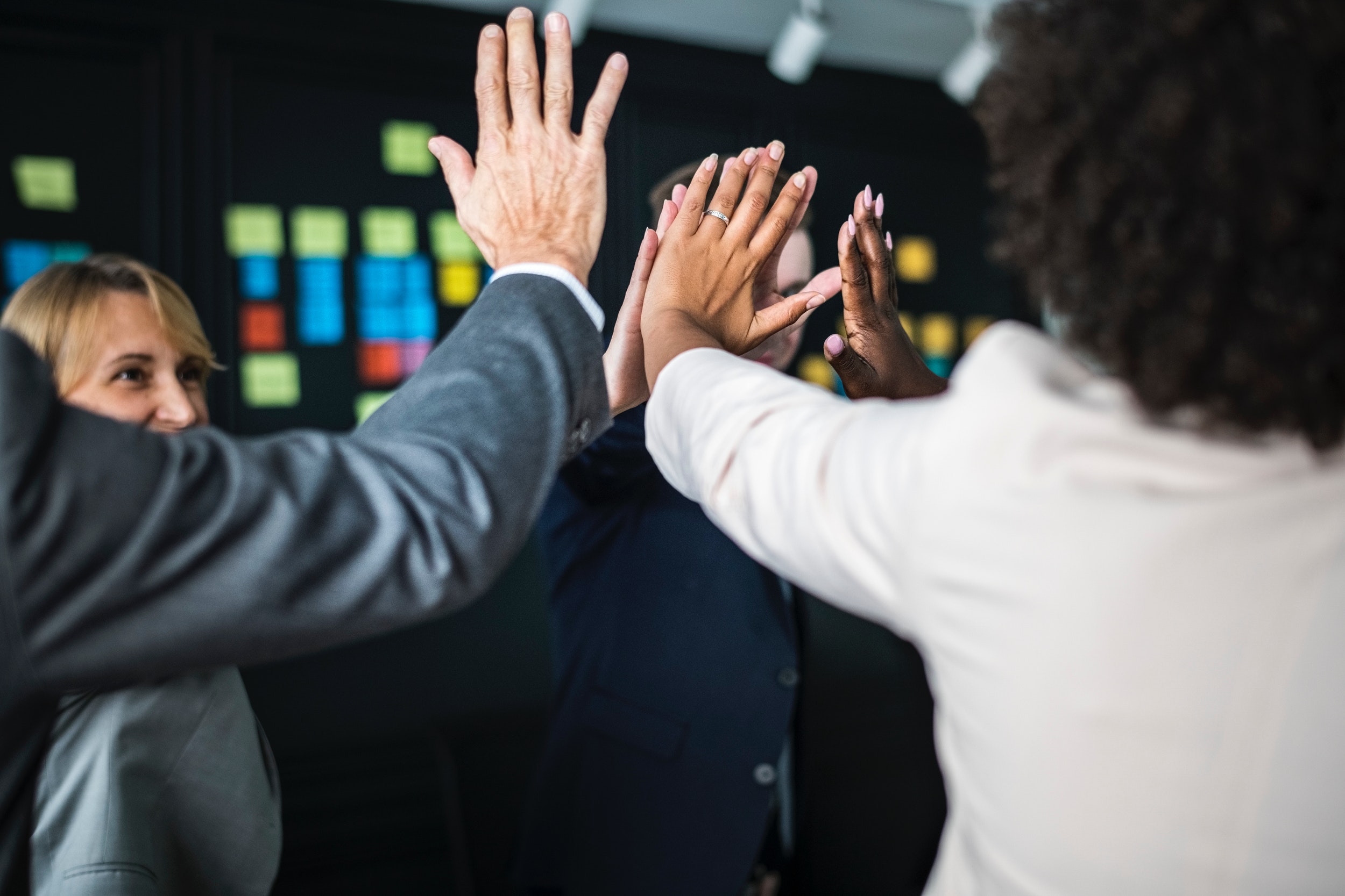 A group of people joining hands in achievement