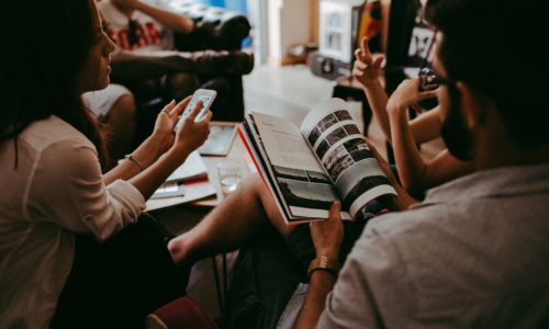 A group pf people meeting, with books and smartphones