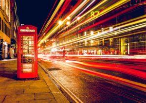 A London road with a red phone box.