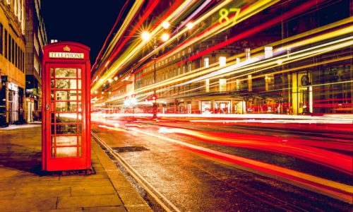 A London road with a red phone box.