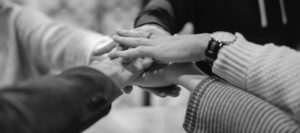 People joining hands as a team